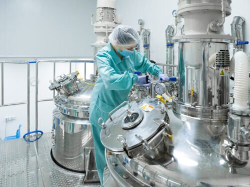 Pharmaceutical technician in sterile environment at pharmacy industry